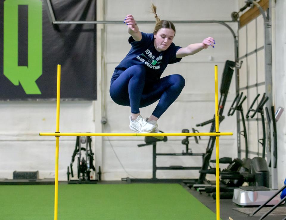 Peoria Notre Dame multi-sport athlete Kaitlyn Cassidy leaps over a bar during a training session at Torq Fitness & Performance in East Peoria.