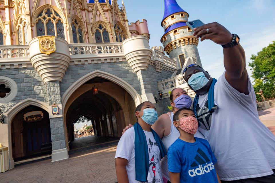 Guests stop to take a selfie at Magic Kingdom Park at Walt Disney World Resort.