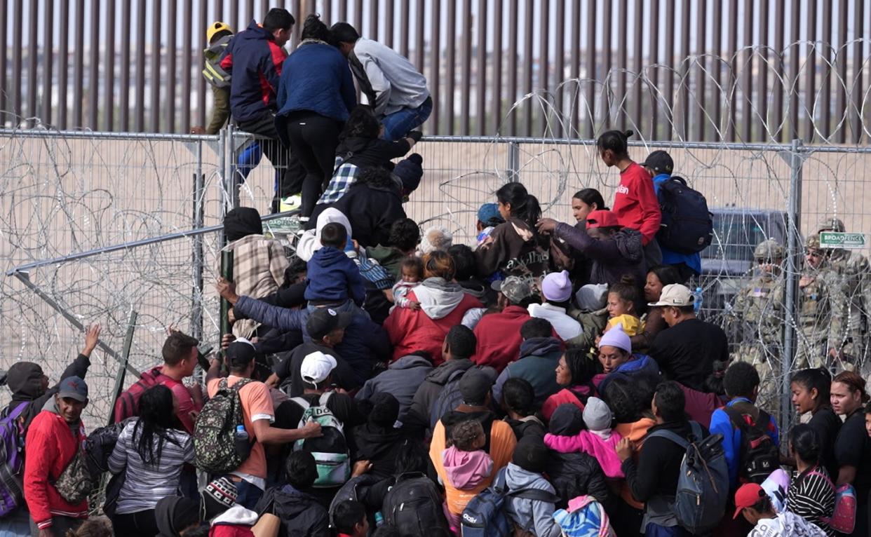 A video still shows Migrants breaching barriers set by the Texas National Guard on the Rio Grande in El Paso, Texas on April 12, 2024.