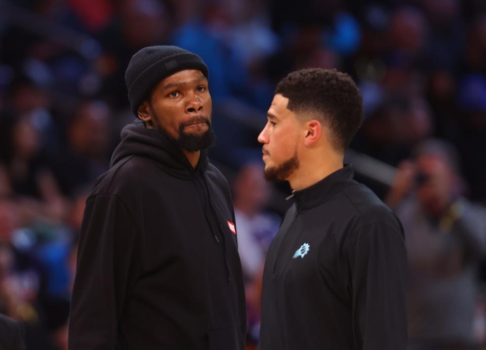 Feb 24, 2023; Phoenix, Arizona, USA; Phoenix Suns forward Kevin Durant (left) and guard Devin Booker against the Oklahoma City Thunder in the first half at Footprint Center. Mandatory Credit: Mark J. Rebilas-USA TODAY Sports