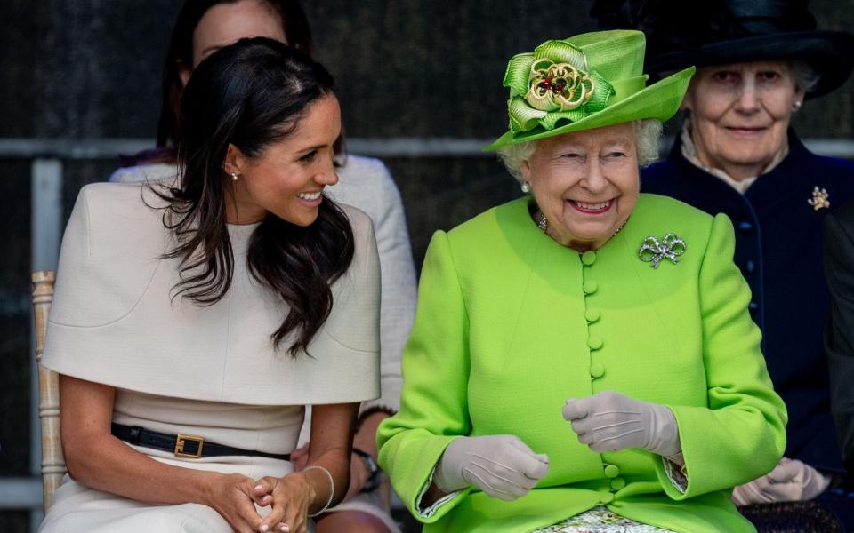 Queen and Meghan Markle smiling together - Mark Cuthbert/UK Press