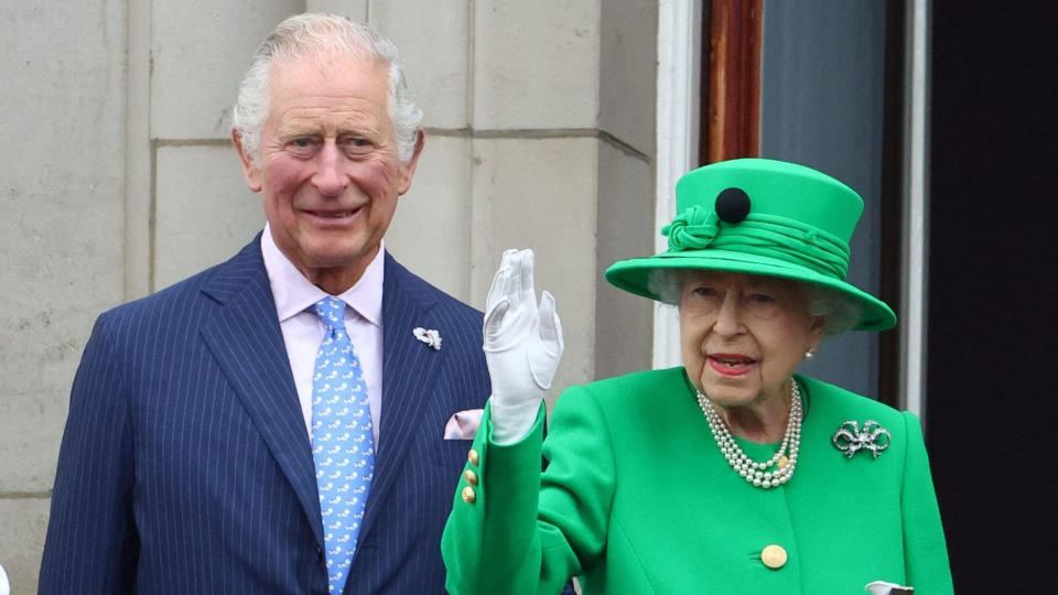 Britain's Queen Elizabeth II stands beside Britain's Prince Charles, Prince of Wales and waves to the public as she appears on Buckingham Palace balcony at the end of the Platinum Pageant in London on June 5, 2022 as part of Queen Elizabeth II's platinum jubilee celebrations. - The curtain comes down on four days of momentous nationwide celebrations to honour Queen Elizabeth II's historic Platinum Jubilee with a day-long pageant lauding the 96-year-old monarch's record seven decades on the throne. (Photo by HANNAH MCKAY / POOL / AFP) (Photo by HANNAH MCKAY/POOL/AFP via Getty Images)