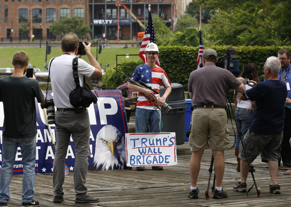 Trump supporter poses with a rifle near the Republican National Convention