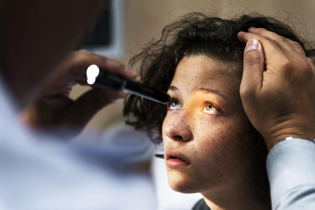 girl getting an eye examination at eye doctor