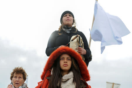 Women hold a demonstration on Backwater Bridge during a protest against plans to pass the Dakota Access pipeline near the Standing Rock Indian Reservation, near Cannon Ball, North Dakota, U.S. November 27, 2016. REUTERS/Stephanie Keith