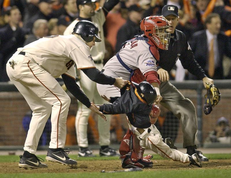 J.T. Snow drags a then 3-year-old Darren Baker out of harms way during the 2002 World Series. The son of Dusty Baker will play baseball at the University of California, Berkeley. (AP)