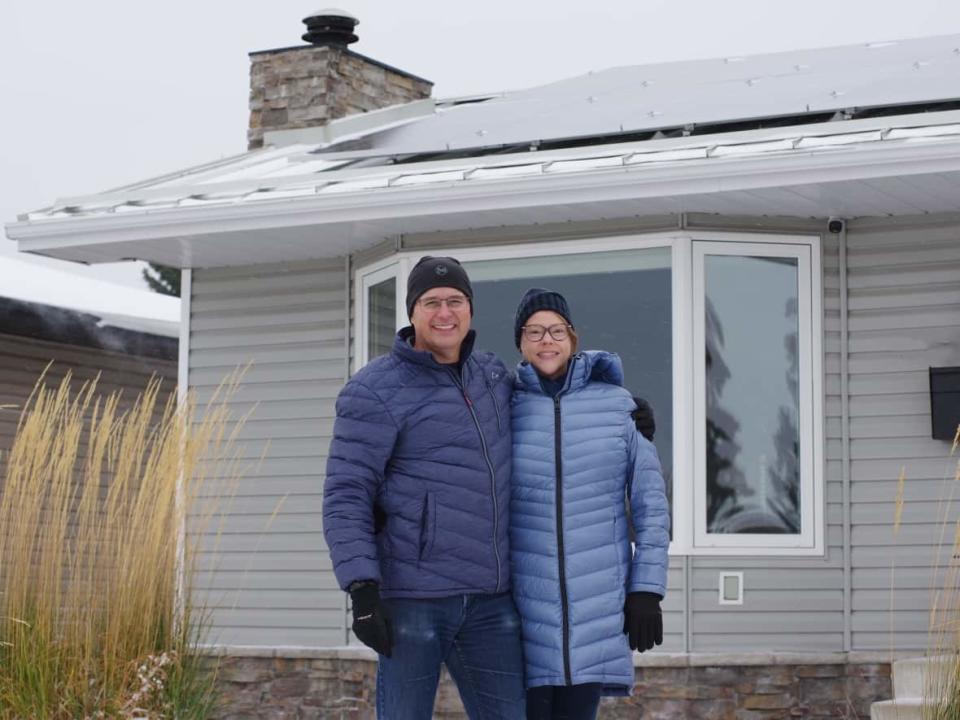 Darcy and Darren Crichton outside their net-zero bungalow. (Submitted by Darcy and Darren Crichton - image credit)