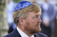 King Willem-Alexander arrives to unveil a new monument in the heart of Amsterdam's historic Jewish Quarter on Sunday, Sept. 19, 2021, honoring the 102,000 Dutch victims of the Holocaust. Designed by Polish-Jewish architect Daniel Libeskind, the memorial is made up of walls shaped to form four Hebrew letters spelling out a word that translates as "In Memory Of." The walls are built using bricks each of which is inscribed with the name of one of the 102,000 Jews, Roma and Sinti who were murdered in Nazi concentration camps during World War II or who died on their way to the camps. (AP Photo/Peter Dejong)