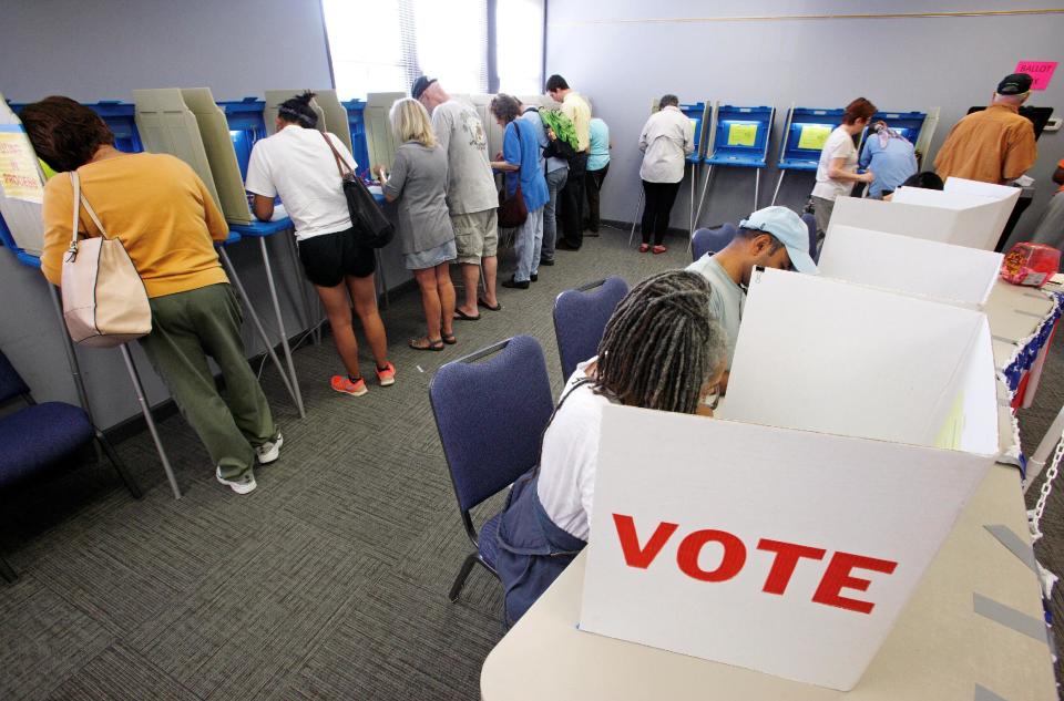 People cast their ballots for the 2016 general elections at a crowded polling station as early voting begins in North Carolina, in Carrboro, North Carolina, U.S., October 20, 2016. REUTERS/Jonathan Drake