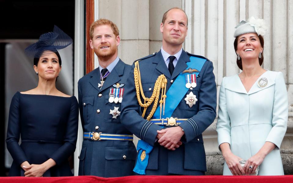 Meghan, Duchess of Sussex, Prince Harry, Duke of Sussex, Prince William, Duke of Cambridge and Catherine, Duchess of Cambridge watch a flypast to mark the centenary of the Royal Air Force from the balcony of Buckingham Palace on July 10, 2018 in London, England