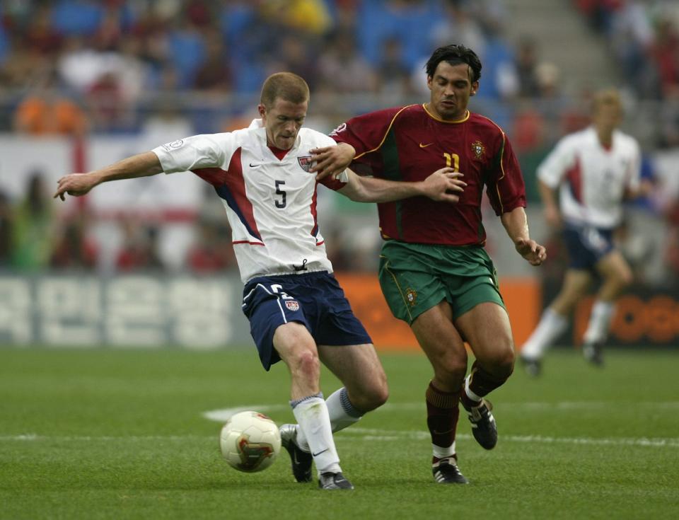 John O'Brien of the USA holds off a challenge from Sergio Conceicao of Portugal during the first half of the Portugal v USA, Group D, World Cup Group Stage match played at the Suwon World Cup Stadium.