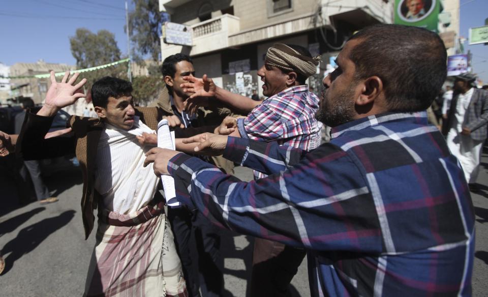 Supporters of the Houthi movement clash with anti-Houthi protesters during a rally in Sanaa