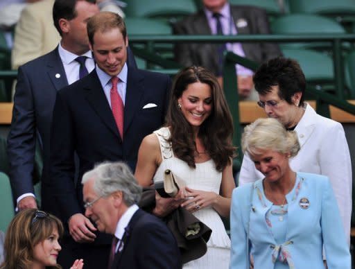 Britain's Prince William (2nd L) and his wife Catherine the Duchess of Cambridge (C) arrive on Centre Court to watch Britain's Andy Murray and France's Richard Gasquet at the Wimbledon Tennis Championships at the All England Tennis Club in London