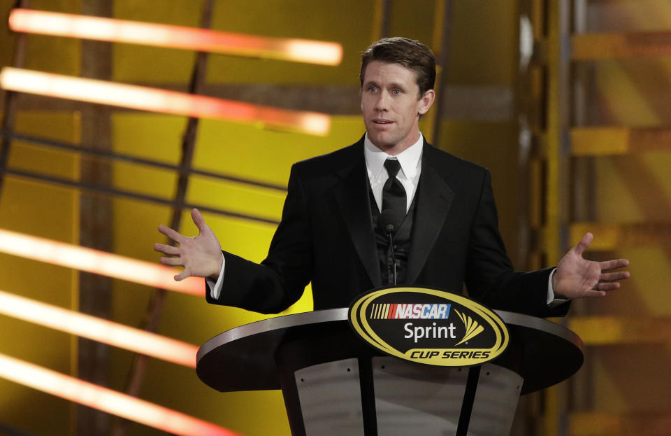 FILE - Carl Edwards speaks during the NASCAR Sprint Cup Series auto racing awards Friday, Dec. 2, 2016, in Las Vegas. Edwards, one of NASCAR’s top 75 drivers, was elected to the NASCAR Hall of Fame last week based on his 28 career Cup victories. He said his election to the Hall was a surprise he didn’t see coming. (AP Photo/John Locher, File)