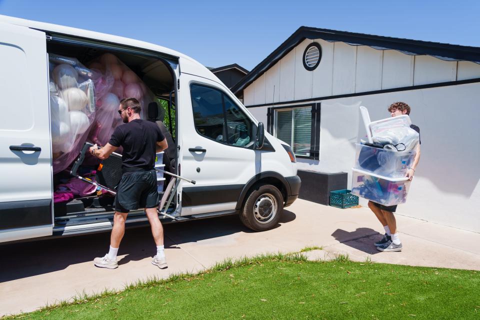 Scottsdale Bachelorette founder and owner, Casey Hohman, left, and Diego Ovalle, right, load equipment into a van before traveling to another client's bachelorette party location on July 7, 2022, in Scottsdale.