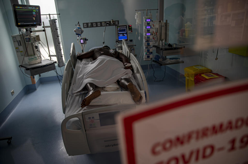 A COVID-19 patient lies in the ICU of the Posta Central Hospital in Santiago, Chile, Friday, June 4, 2021. Chile's Health Ministry reported that 97% of the nation's ICU hospital beds are full, with the majority holding COVID-19 patients. (AP Photo/Esteban Felix)