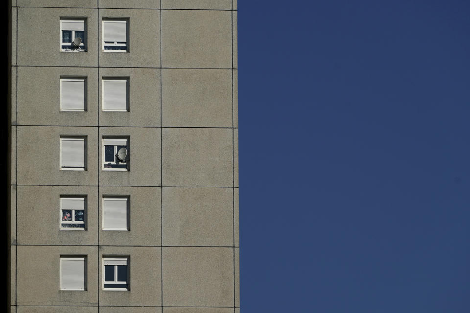 In this Wednesday, April 15, 2020 photo, a view of a building in the Minguettes district of Venissieux, a suburb of Lyon, central France. They can’t expect much sympathy, but lockdowns and travel restrictions mean small-time drug dealers can’t do business as usual during the coronavirus pandemic. Street sellers in Brussels and Paris have changed their work hours and delivery methods due to the end of public nightlife and a drop in demand. The young sellers complete transactions in building lobbies or staircases now instead of out in the open. (AP Photo/Laurent Cipriani)