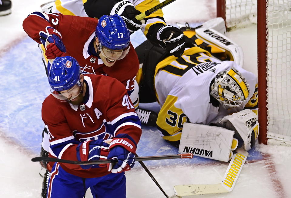 Montreal Canadiens' Paul Byron (41) celebrates his goal on Pittsburgh Penguins goaltender Matt Murray (30) with teammate Max Domi (13) during the second period of an NHL hockey playoff game Wednesday, Aug. 5, 2020 in Toronto. (Frank Gunn/The Canadian Press via AP)