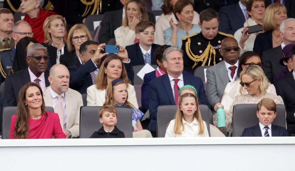 LONDON, ENGLAND - JUNE 05: (L-R 2nd row) Mike Tindall, Victoria Starmer, Mia Tindall, Keir Starmer, Zara Tindall (front row) Catherine, Duchess of Cambridge, Prince Louis of Cambridge, Princess Charlotte of Cambridge and Prince George of Cambridge watch the Platinum Pageant on June 05, 2022 in London, England. The Platinum Jubilee of Elizabeth II is being celebrated from June 2 to June 5, 2022, in the UK and Commonwealth to mark the 70th anniversary of the accession of Queen Elizabeth II on 6 February 1952. (Photo by Chris Jackson - WPA Pool/Getty Images)