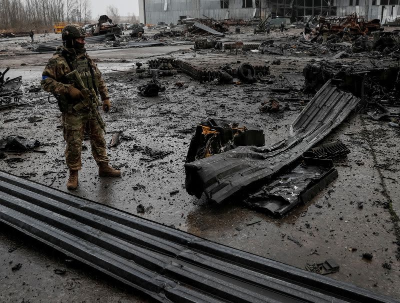 FILE PHOTO: A Ukrainian service member inspects a compound of the Antonov airfield in the settlement of Hostomel