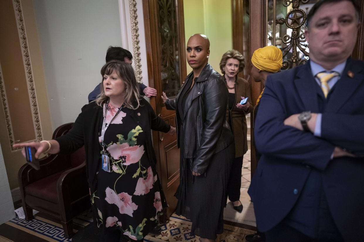 Rep. Ayanna Pressley, D-Mass., center left, and Rep. Ilhan Omar, D-Minn., center right talking to Sen. Debbie Stabenow, D-Mich., return to the House after members of the House Progressive Caucus went to the Senate chamber and shouted in protest ahead of a procedural vote on the Women's Health Protection Act to codify the landmark 1973 Roe v. Wade decision that legalized abortion nationwide, at the Capitol in Washington, Wednesday, May 11, 2022. (AP Photo/J. Scott Applewhite)