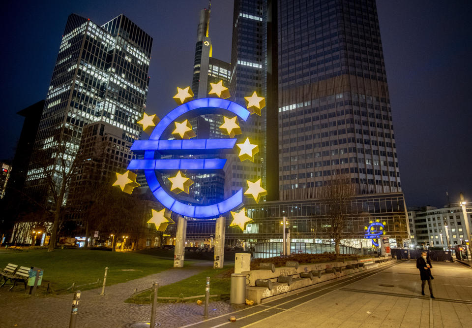 A man walks past the Euro sculpture in Frankfurt, Germany, Thursday, March 11, 2021. The European Central Bank will have a meeting of the governing council on Thursday. (AP Photo/Michael Probst)