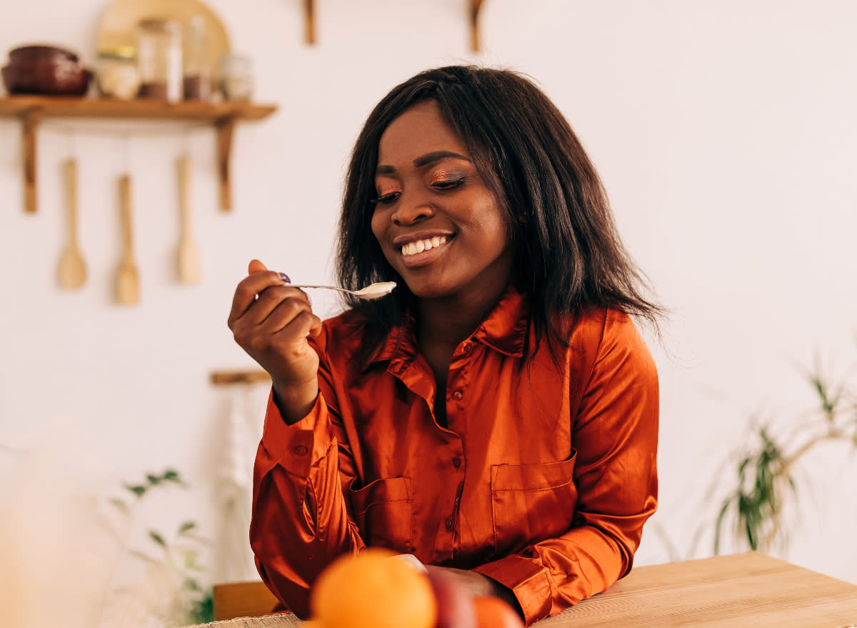 woman eating yogurt, concept of best breakfast for weight loss