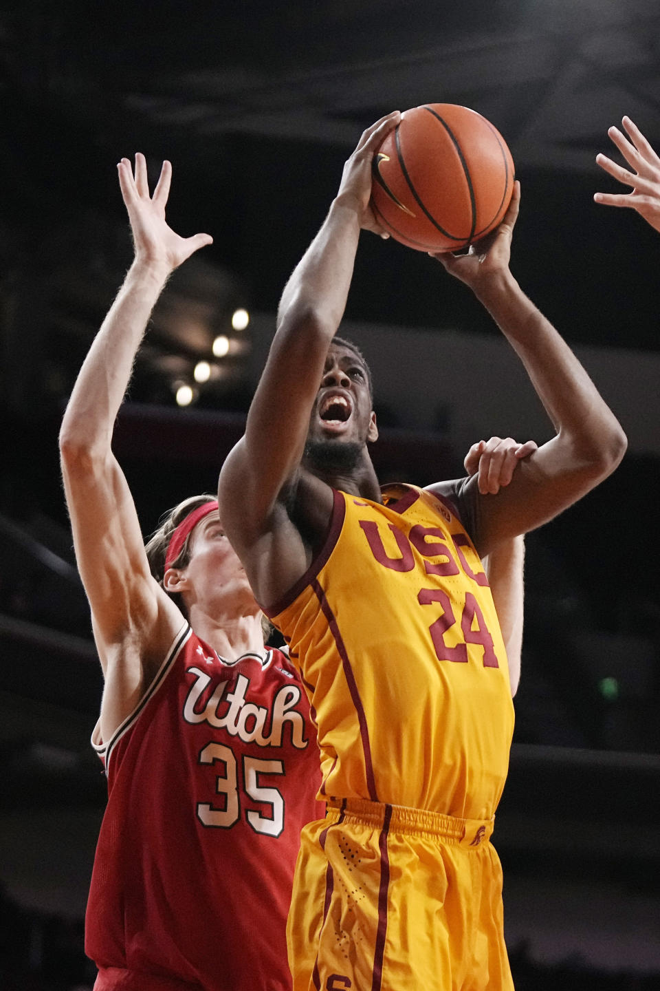 Southern California forward Joshua Morgan, right, shoots as Utah center Branden Carlson defends during the first half of an NCAA college basketball game Thursday, Feb. 15, 2024, in Los Angeles. (AP Photo/Mark J. Terrill)