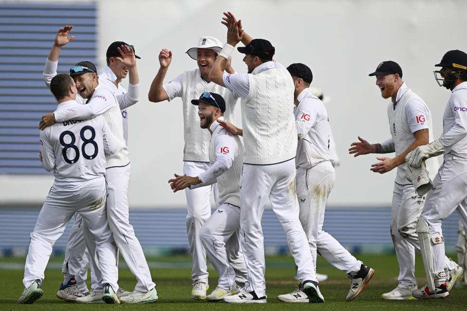 England's Harry Brook, left, is congratulated by teammates after taking the wicket of New Zeraland's Kane Willaimson on day 4 of their cricket test match in Wellington, New Zealand, Monday, Feb 27, 2023. (Andrew Cornaga/Photosport via AP)