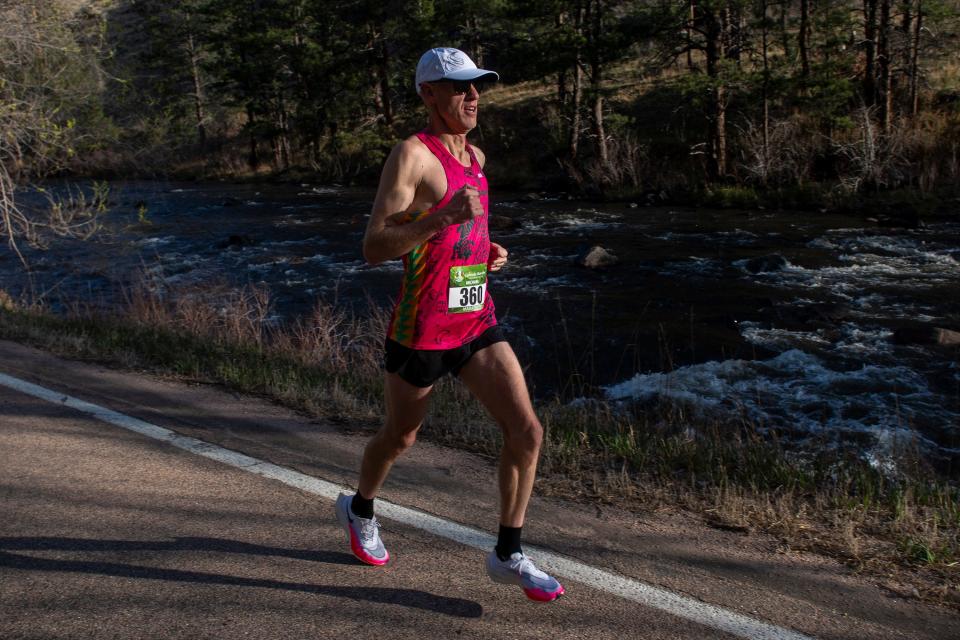 Michael Kraus of Erie, Colorado, runs down the Poudre Canyon during the Colorado Marathon on Sunday. Kraus won the marathon at 2:36:15.