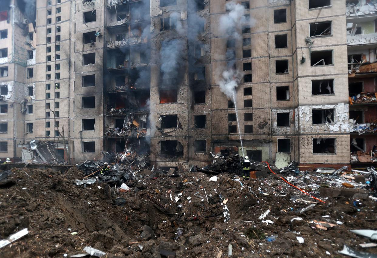 Firefighters attempt to extinguish a fire in a multi-storey building destroyed by a missile attack in central Kyiv, on Jan. 2 amid the Russian invasion of Ukraine.