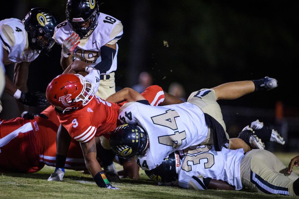 Jackson Karcher (44) tackles Anthony Quinn Jr. (3) during Gray’s Creek at Seventy First football on Friday, Sept. 23, 2022.