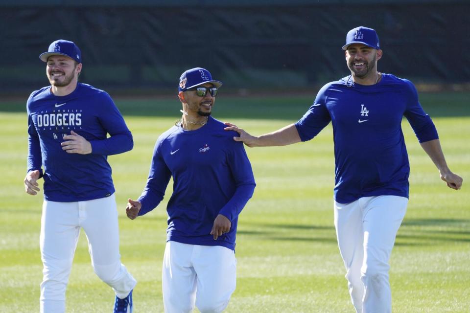 The Dodgers' Gavin Lux, Mookie Betts and J.D. Martinez run during a spring training workout in Phoenix