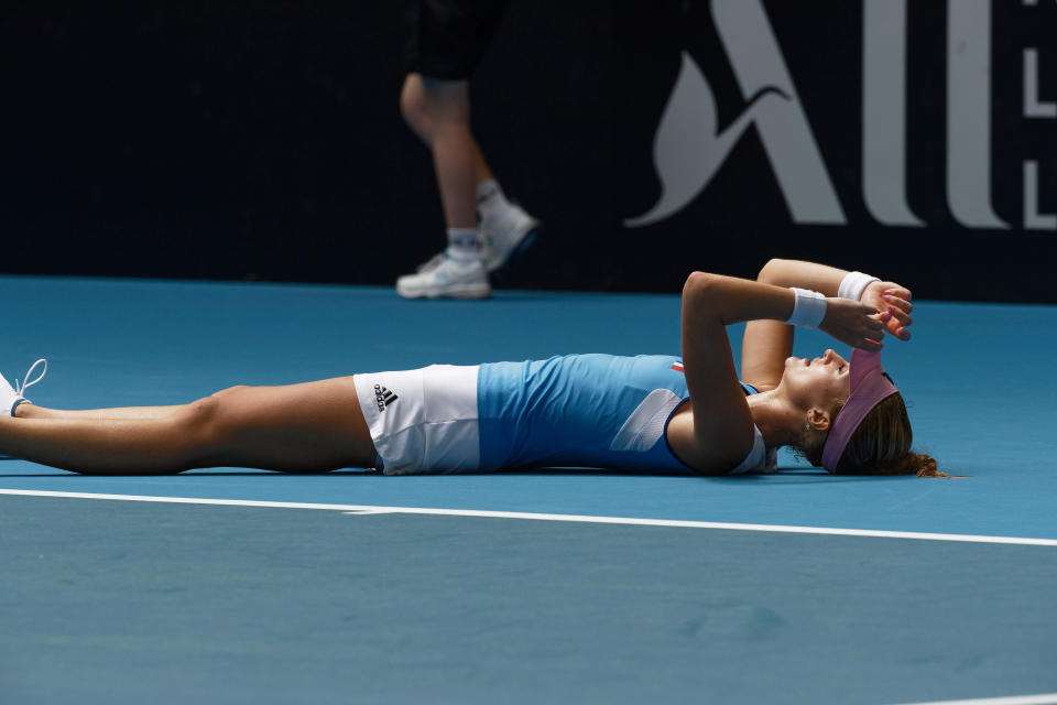France's Kristina Mladenovic lies on the court after winning her match against Australia's Ash Barty during their Fed Cup tennis final in Perth, Australia, Sunday, Nov. 10, 2019. (AP Photo/Trevor Collens)