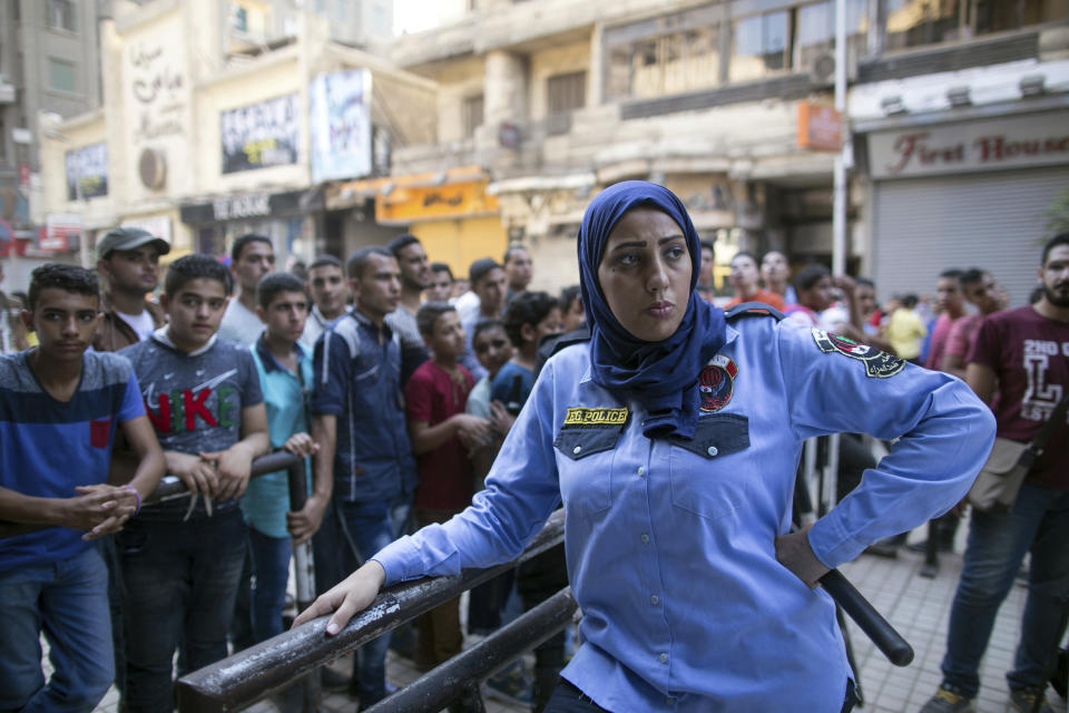 FILE - In this July 17, 2015 file photo, an Egyptian policewoman from a newly formed force to combat sexual harassment in the streets is deployed in Cairo on the first day of Eid Al-Fitr. A video posted on Facebook Aug. 15, 2018, by an Egyptian woman who says a man stalked her at a bus stop has stirred online debate, with many -- including women -- taking the man’s side. Some say he was politely flirting and the woman overreacted, while others have speculated about what she was wearing, suggesting she was the one at fault. The diverging responses point to the difficulty in combatting the rampant sexual harassment on Egypt’s streets. (AP Photo/Roger Anis, File)
