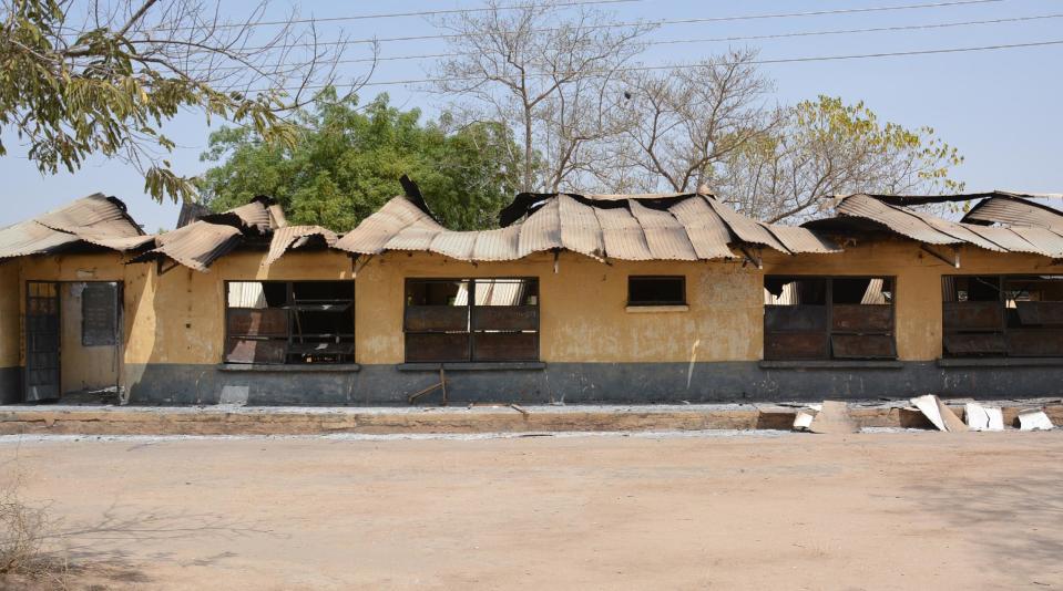 This Tuesday, Feb. 25, 2014, photo, shows the remains of the burned out Federal Government College in Buni Yadi, Nigeria. Islamic militants killed dozens of students in a pre-dawn attack Tuesday on the northeast Nigerian school, survivors said, setting ablaze a locked dormitory and shooting and slitting the throats of those who escaped through windows. Some were burned alive. (AP Photo)