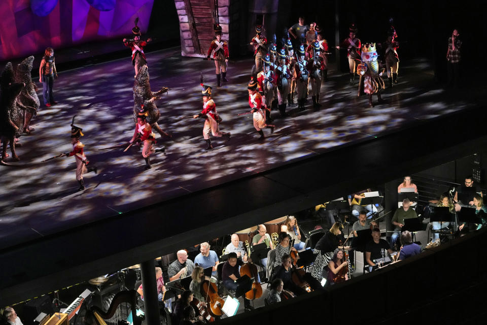 Ballet Arizona musicians, bottom, and dancers rehearse for the "Nutcracker", Thursday, Dec. 7, 2023, in Phoenix prior to an upcoming performance. A pit full of musicians is part of the tradition of the holiday staple for Ballet Arizona and many other productions around the world. Shows use recordings as they weather costs or crises like recessions. But fans, musicians and the unions that represent them say the live music brings an unseen signature to each show. (AP Photo/Matt York)