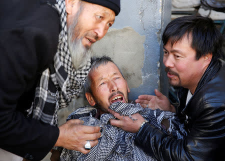 An Afghan man mourns inside a hospital compound after a suicide attack in Kabul, Afghanistan December 28, 2017. REUTERS/Mohammad Ismail