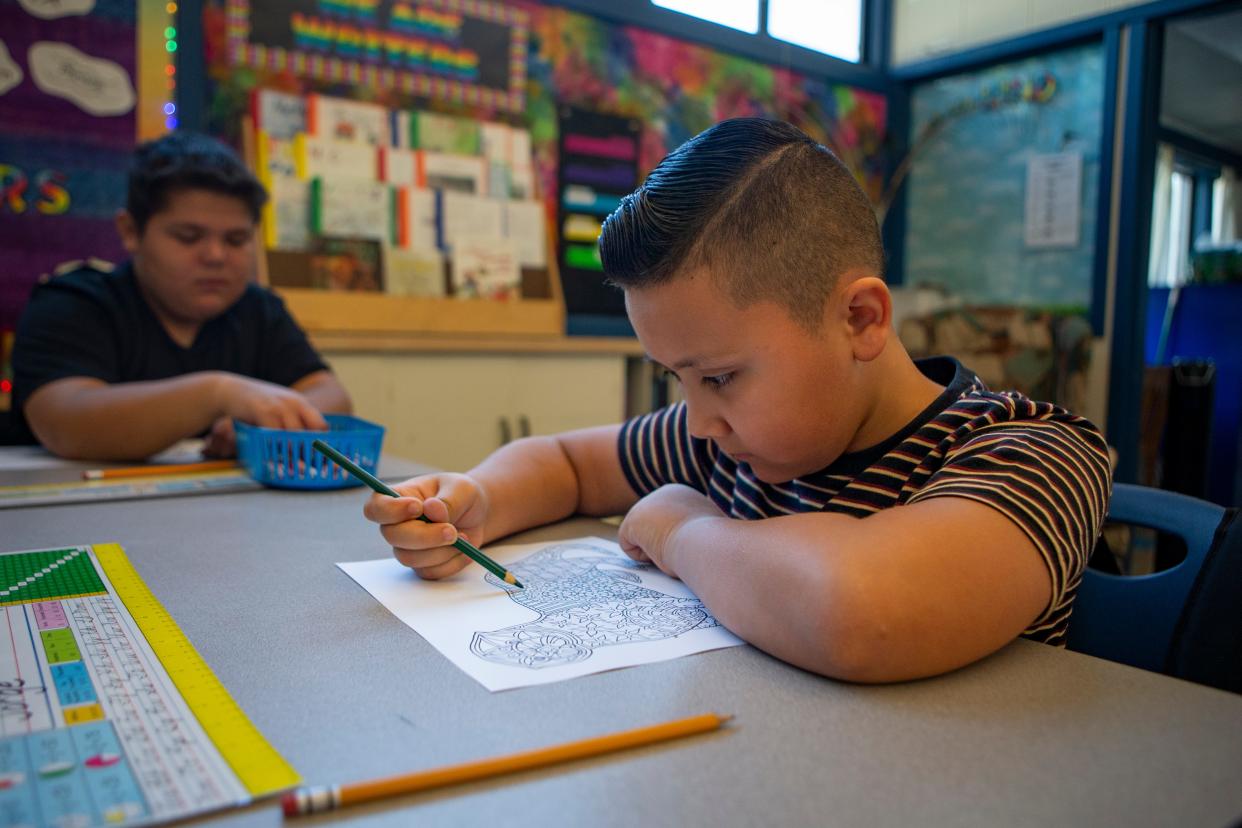 Fifth-grader Jorge, 10, colors as students settle in on the first day of school on Sept. 7 at Two Rivers-Dos Rios Elementary School in Springfield.