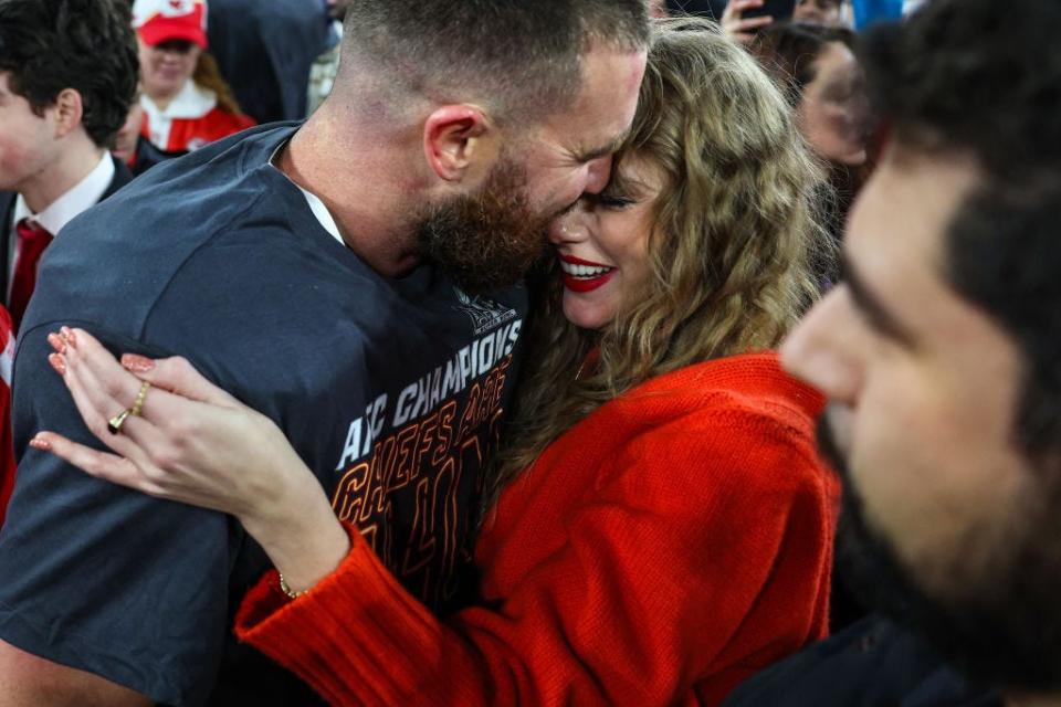 Travis Kelce kissing Taylor Swift after the Chiefs qualified for the Super Bowl.