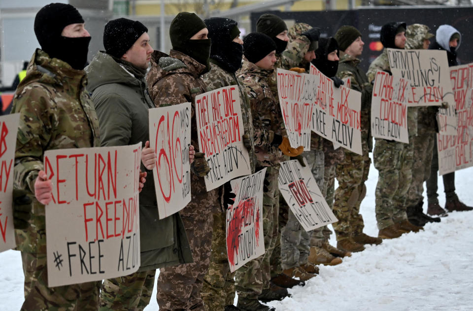 Relatives and brothers-in-arms of Ukrainian prisoners of war from the Azov Brigade hold placards at a rally in Kyiv, Ukraine, Jan. 21, 2024, to call for their release iin an exchange for Russian prisoners, amid Russia's ongoing invasion of Ukraine. / Credit: SERGEI SUPINSKY/AFP/Getty