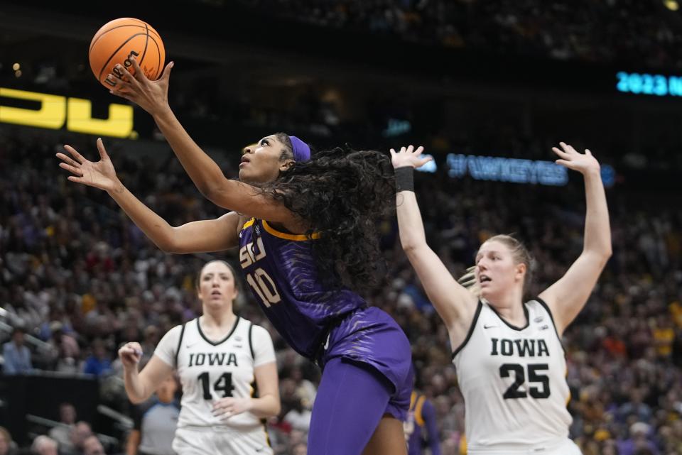 LSU's Angel Reese shoots past Iowa's Monika Czinano and McKenna Warnock during the second half of the NCAA Women's Final Four championship basketball game Sunday, April 2, 2023, in Dallas. (AP Photo/Darron Cummings)