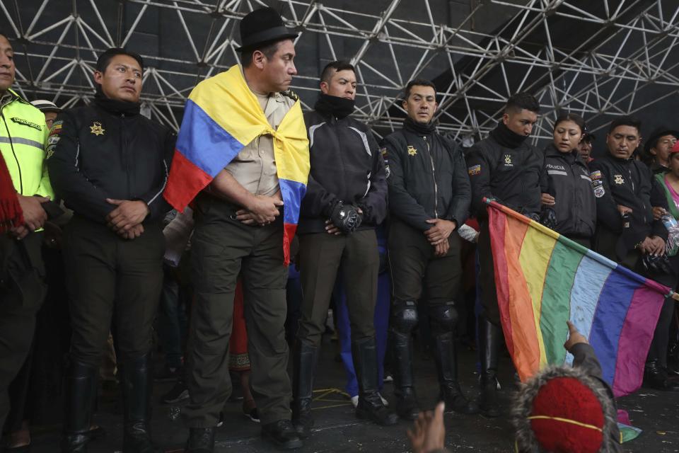 Police detained by anti-governments protesters are presented on a stage in Quito, Ecuador, Thursday, Oct. 10, 2019. Thousands of protesters staged anti-government rallies Wednesday, seeking to intensify pressure on Ecuador's president after a week of unrest sparked by fuel price hikes. (AP Photo/Fernando Vergara)
