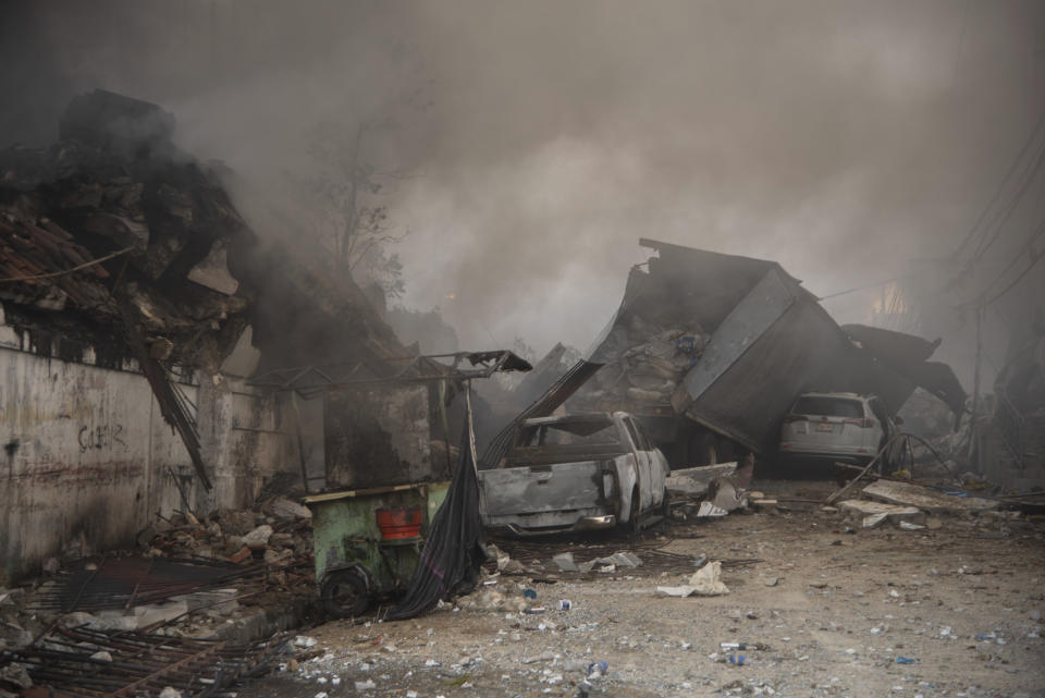 Destroyed vehicles and debris are scattered on the ground after a powerful explosion in San Cristobal, Dominican Republic, Monday, Aug 14, 2023. The Monday afternoon explosion killed at least three people and injured more than 30 others, authorities said. (Jolivel Brito/Diario Libre via AP)