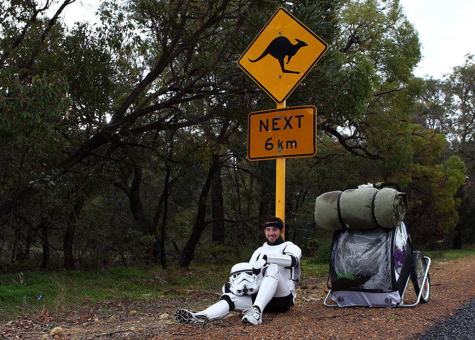 PERTH, AUSTRALIA - JULY 15: Stormtrooper Paul French is pictured on day 5 of his over 4,000 kilometre journey from Perth to Sydney taking a rest break on Old Mandurah Road on July 15, 2011 in Perth, Australia. French aims to walk 35-40 kilometres a day, 5 days a week, in full Stormtrooper costume until he reaches Sydney. French is walking to raise money for the Starlight Foundation - an organisation that aims to brighten the lives of ill and hostpitalised children in Australia. (Photo by Paul Kane/Getty Images)