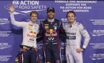 (L-R) Red Bull Formula One driver Sebastian Vettel of Germany, Red Bull Formula One driver Mark Webber of Australia and Mercedes Formula One driver Nico Rosberg of Germany pose for photographers after the qualifying session of the Abu Dhabi F1 Grand Prix at the Yas Marina circuit on Yas Island, November 2, 2013. Webber put Red Bull on pole position for the floodlit Abu Dhabi Formula One Grand Prix on Saturday in a front row sweep with quadruple world champion team mate Sebastian Vettel. REUTERS/Caren Firouz (UNITED ARAB EMIRATES - Tags: SPORT MOTORSPORT F1)