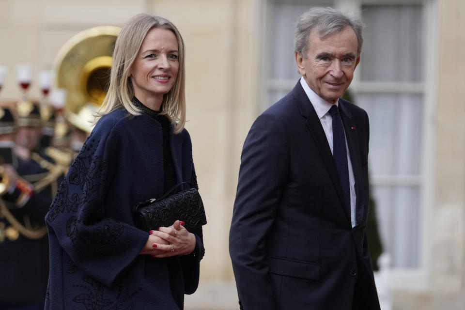 LVMH luxury group CEO Bernard Arnault and his daughter Delphine arrive for a state diner hosted by French President Emmanuel Macron for China's President Xi Jinping at the Elysee Palace, Monday, May 6, 2024 in Paris. (AP Photo/Thibault Camus)
