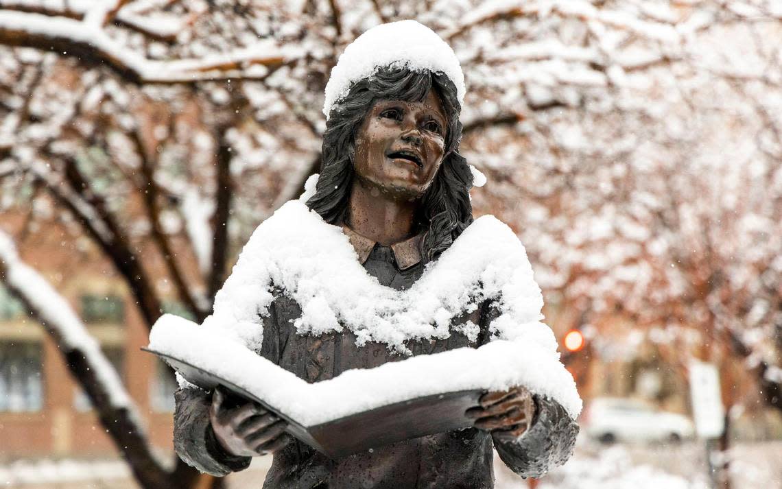 It’s beginning to look a lot like … winter. Snow covers a bronze statue in front of Esther Simplot Perorming Arts Acadamy in downtown Boise, Monday, Dec. 12, 2022, after an overnight storm left several inches of snow in the Treasure Valley.