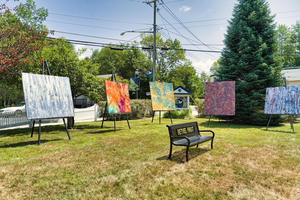 Park bench surrounded by art in Kauneonga Lake, NY