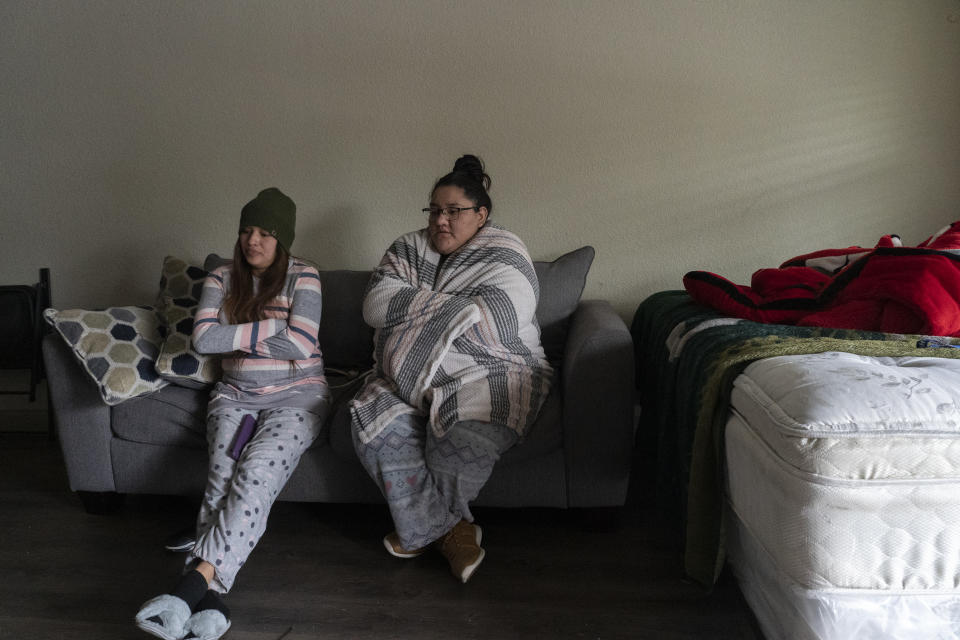 Karla Perez and Esperanza Gonzalez stay in their apartment during power outage caused by the winter storm on February 16, 2021 in Houston, Texas. (Photo by Go Nakamura/Getty Images)